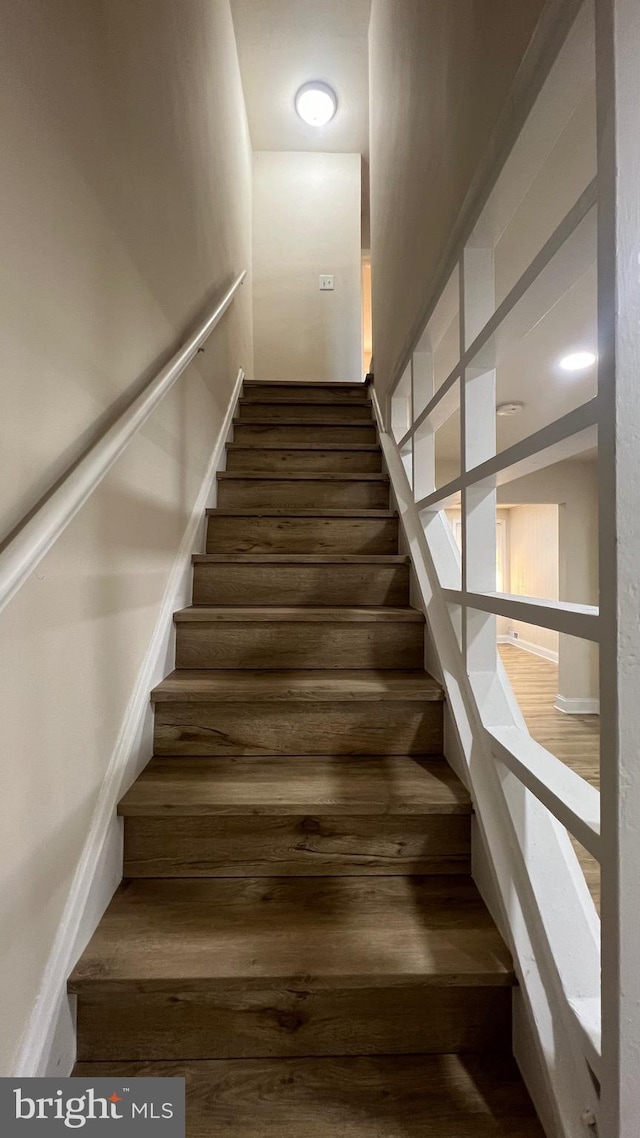 stairway featuring hardwood / wood-style floors