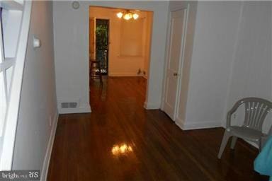 hallway featuring dark hardwood / wood-style flooring