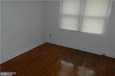 spare room with dark hardwood / wood-style floors