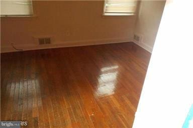 unfurnished room with wood-type flooring