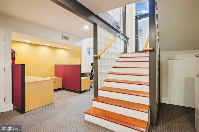 stairs featuring carpet