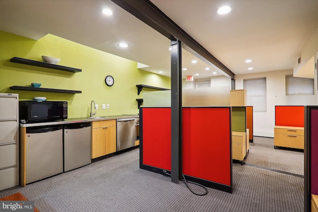 kitchen with beamed ceiling, sink, light carpet, and stainless steel appliances