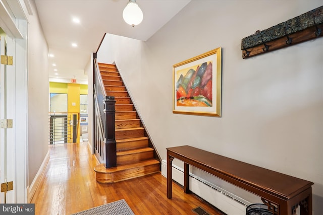 stairway featuring wood-type flooring