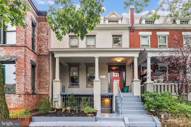 townhome / multi-family property with covered porch