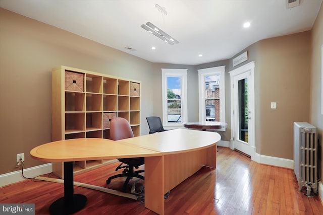 office area featuring radiator and light wood-type flooring