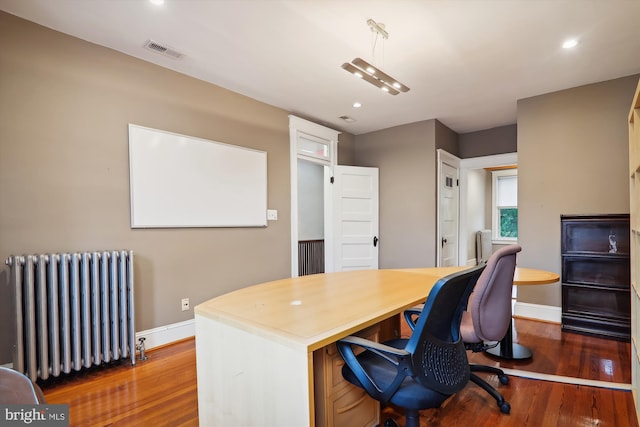 office featuring radiator heating unit and dark hardwood / wood-style floors