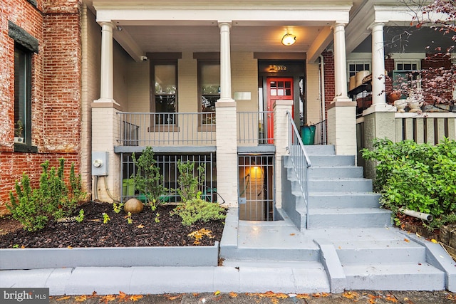 view of exterior entry featuring covered porch