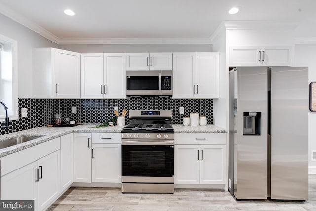 kitchen featuring white cabinetry, sink, and appliances with stainless steel finishes