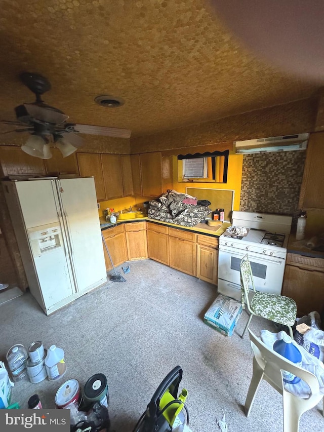 kitchen with white appliances, ceiling fan, and extractor fan