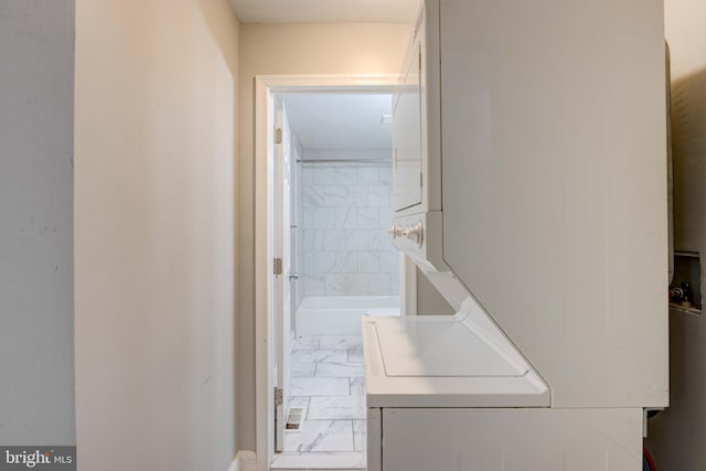 laundry room with stacked washer and dryer