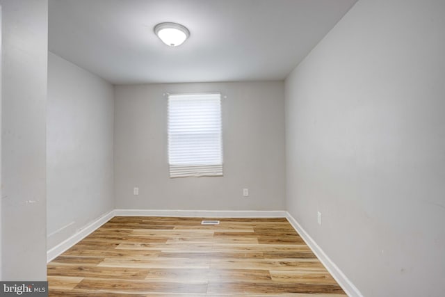 unfurnished room with light wood-type flooring