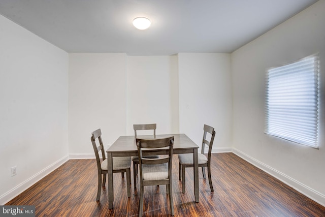 dining area with dark hardwood / wood-style flooring