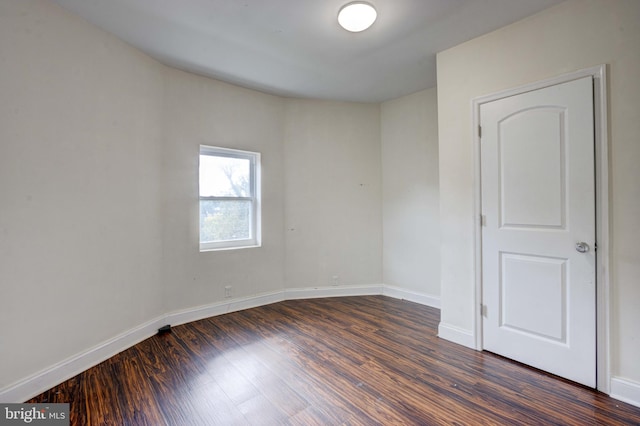 empty room featuring dark hardwood / wood-style floors