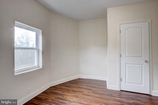 spare room featuring dark hardwood / wood-style flooring