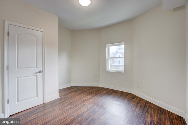 unfurnished room featuring dark hardwood / wood-style flooring