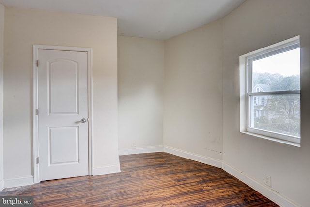 spare room with dark hardwood / wood-style floors