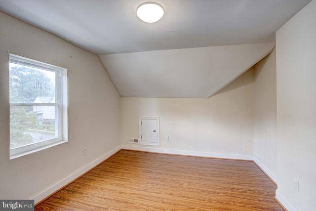 bonus room with lofted ceiling and light hardwood / wood-style flooring