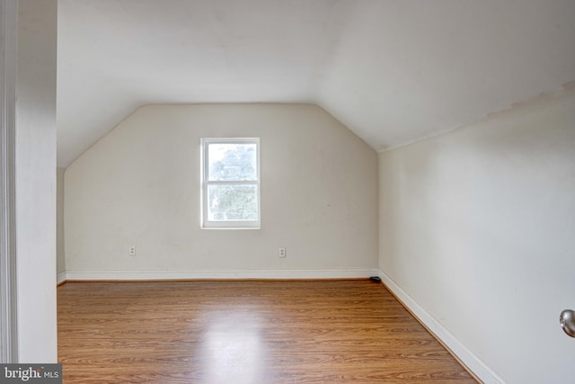 bonus room featuring light hardwood / wood-style floors and vaulted ceiling