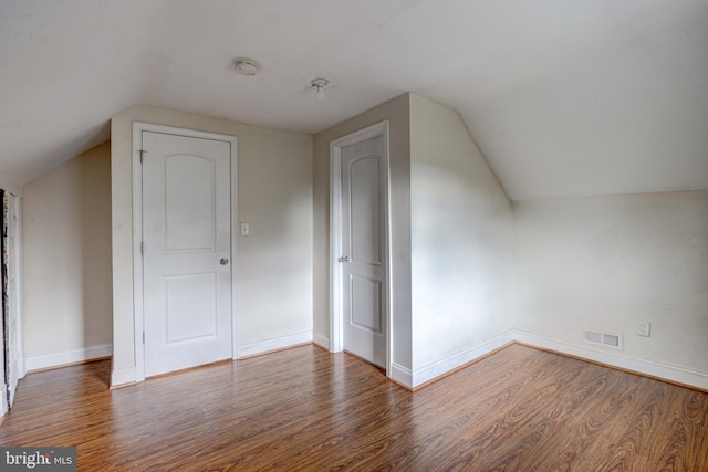 additional living space with lofted ceiling and hardwood / wood-style floors