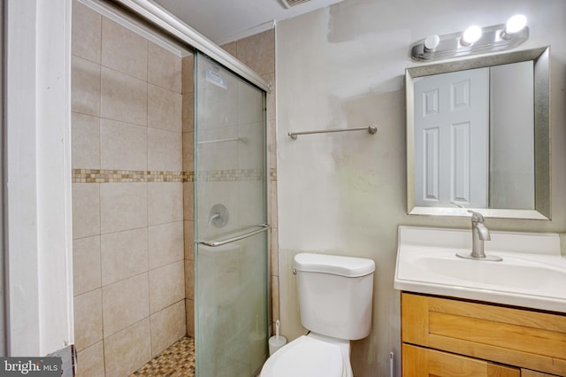 bathroom with vanity, toilet, and an enclosed shower