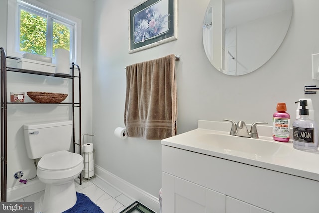 bathroom featuring vanity and toilet