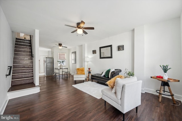 living room featuring dark hardwood / wood-style floors and ceiling fan