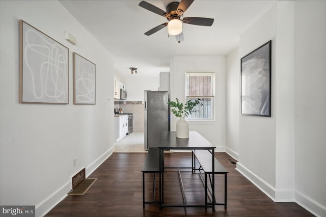 dining room featuring ceiling fan and dark hardwood / wood-style flooring