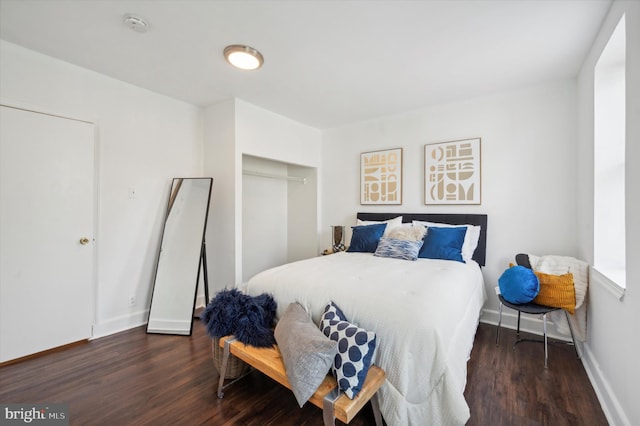 bedroom with a closet and dark hardwood / wood-style flooring