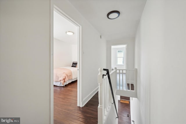 hallway with dark hardwood / wood-style flooring