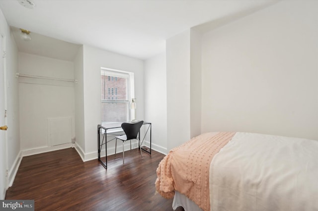 bedroom with dark wood-type flooring