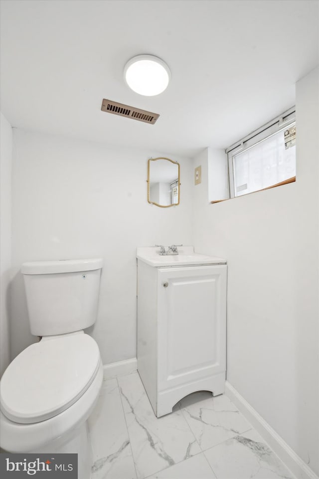 bathroom featuring vanity and toilet