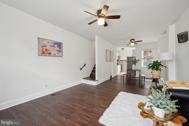 living room with dark wood-type flooring and ceiling fan