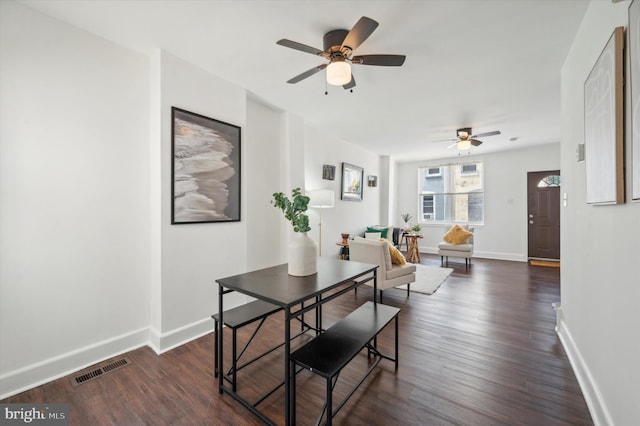 dining area with dark hardwood / wood-style floors and ceiling fan