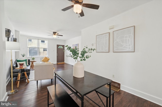 dining area featuring ceiling fan and dark hardwood / wood-style flooring