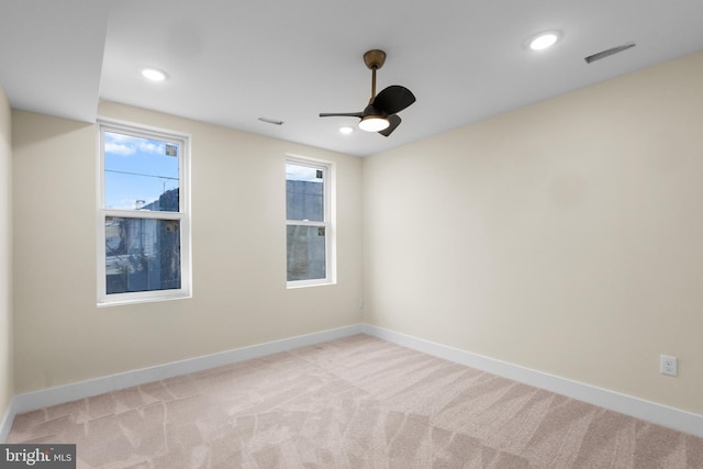 carpeted empty room featuring ceiling fan