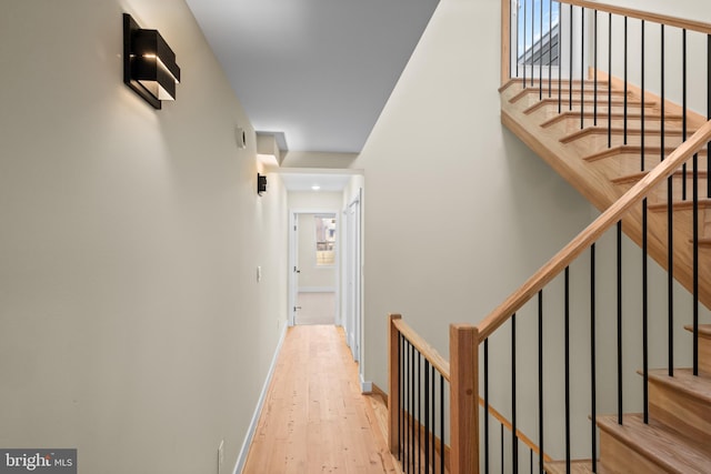 corridor with light hardwood / wood-style floors