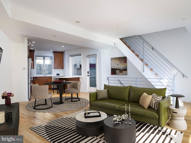 living room featuring light hardwood / wood-style flooring and sink