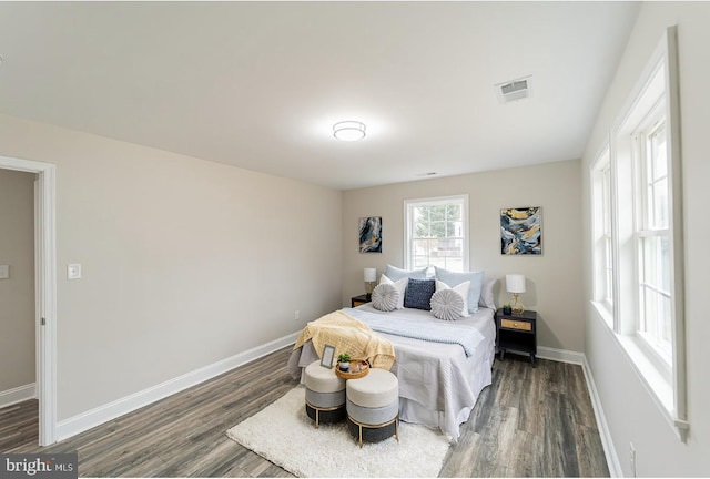 bedroom with dark wood-type flooring