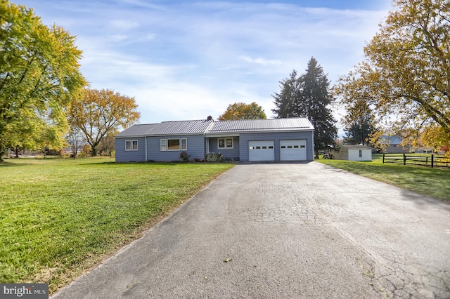 ranch-style house featuring a front yard and a garage