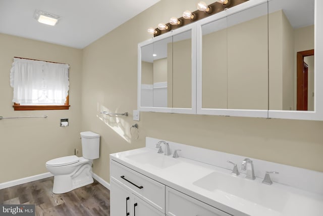 bathroom with vanity, toilet, and hardwood / wood-style flooring