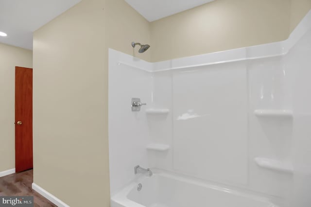 bathroom featuring hardwood / wood-style flooring and shower / bath combination