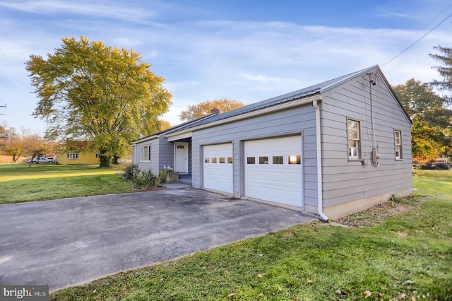 garage featuring a lawn