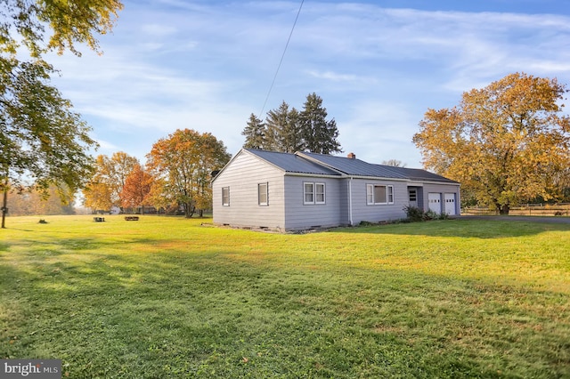 view of side of property with a lawn