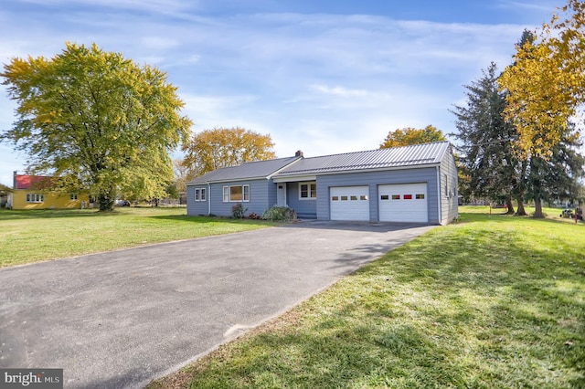 view of front of home with a front lawn and a garage