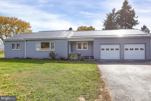 ranch-style house with a garage and a front lawn