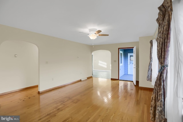 empty room with wood-type flooring and ceiling fan