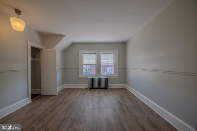 bonus room featuring radiator and hardwood / wood-style flooring