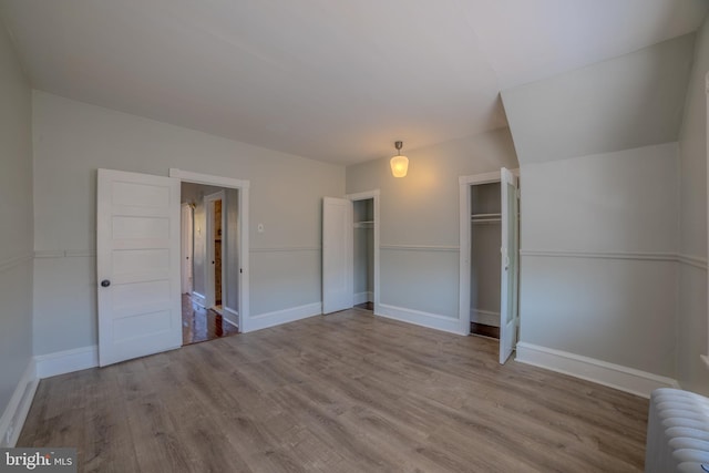 unfurnished bedroom featuring light hardwood / wood-style floors and radiator