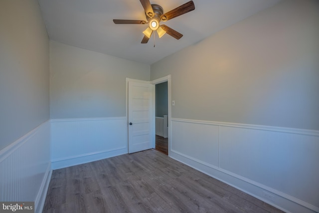 empty room featuring light wood-type flooring and ceiling fan