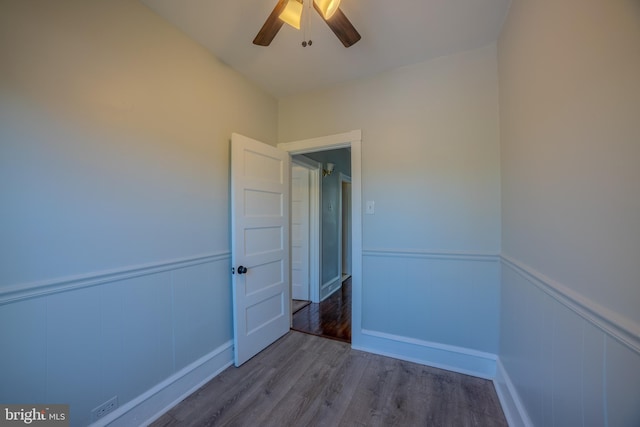 empty room with hardwood / wood-style floors and ceiling fan